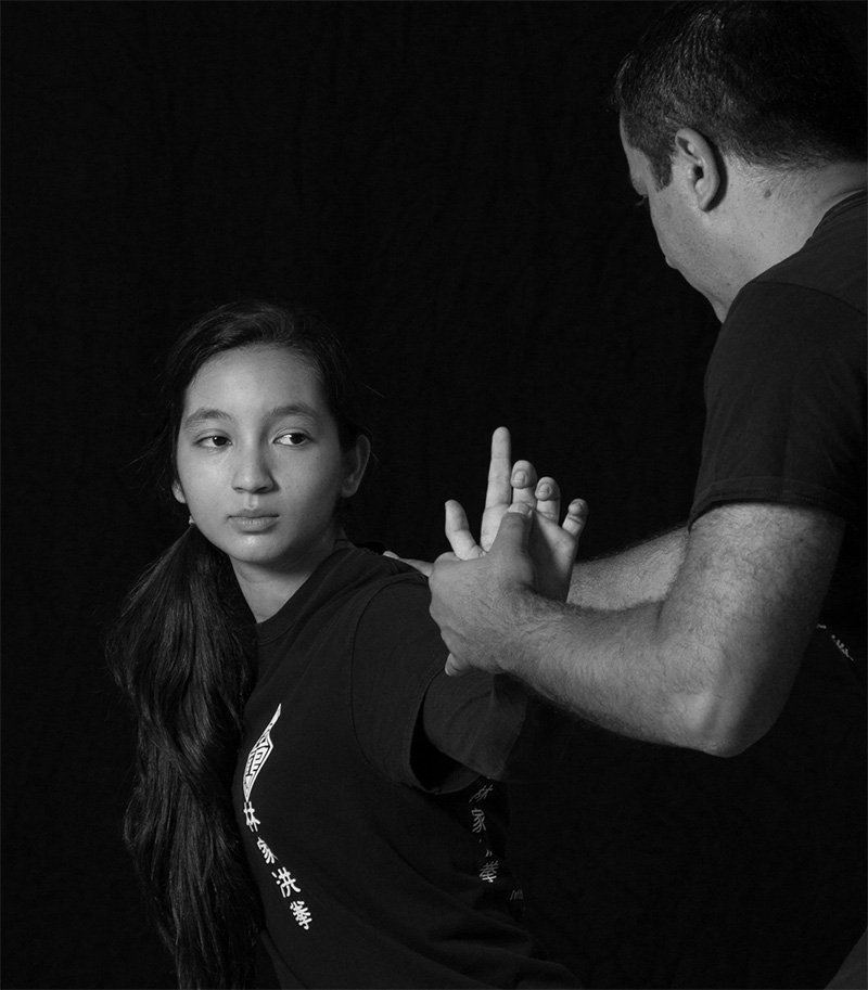 Sifu Leon Dogan providing hands-on instruction in traditional Kung Fu hand techniques.